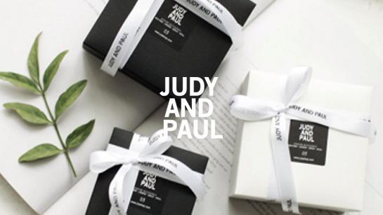 Judy and Paul 리브랜딩 후 패키지 — 블랙 앤 화이트 박스와 브랜드 리본